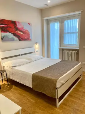 Letto o letti in una camera di Maison Altinia, locazione in centro storico a due passi dalla stazione