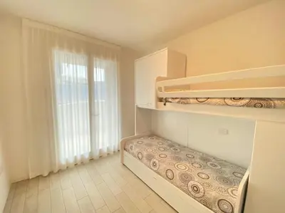 Letto o letti in una camera di Appartamenti Wave Village 2 - Carraro Immobiliare - Family Apartments