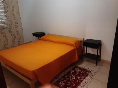 Letto o letti in una camera di Locazione Menini - Appartamento zona stazione