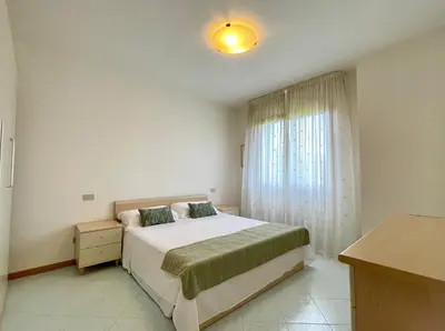 Letto o letti in una camera di Residence Ca D'Oro con piscina Cavallino - Carraro Immobilare - Family Apartments