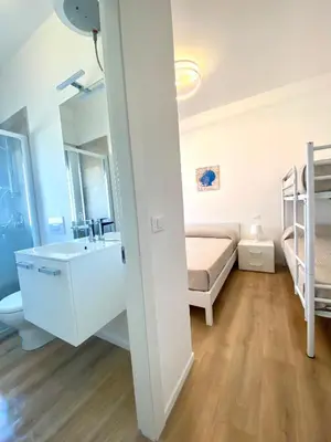 Letto o letti in una camera di Maria Luisa - Piazza Mazzini - 30 MT dal mare - Jesolo