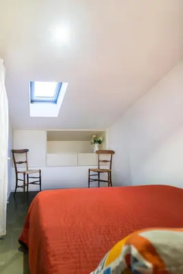 Letto o letti in una camera di MANSARDINA - 1 min from Accademia - duplex stylish and cosy
