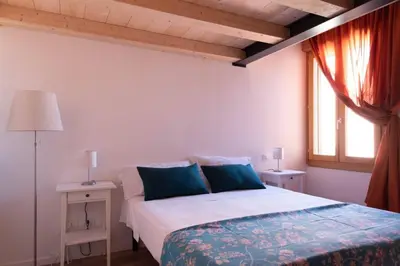 Letto o letti in una camera di enJoy Home - Mansarda Piccolo Tesoro in centro città