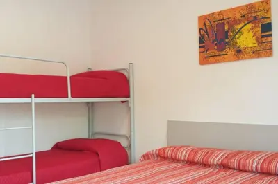 Letto o letti in una camera di RESIDENCE QUITO PIAZZA MAZZINI 150m dal mare e vicino Pista Azzurra