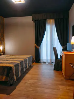 Letto o letti in una camera di LAERTE PALACE HOTEL