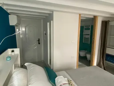 Letto o letti in una camera di LAGUNA BLU Camera CIELO con terrazza panoramica in comune