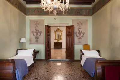 Letto o letti in una camera di Palazzo Valmarana Braga