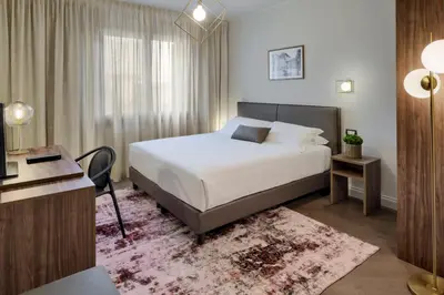 Letto o letti in una camera di Porta Altinia Suites