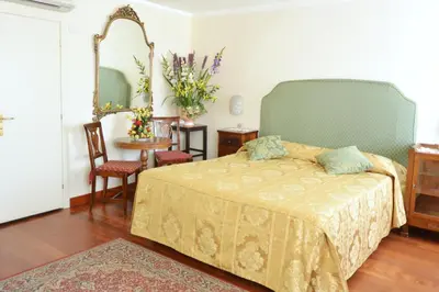 Letto o letti in una camera di Hotel San Zulian