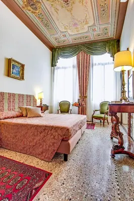 Letto o letti in una camera di Palazzo Schiavoni Residenza d'epoca & Suite-Apartments