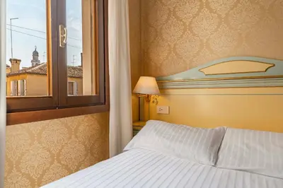 Letto o letti in una camera di Hotel Falier