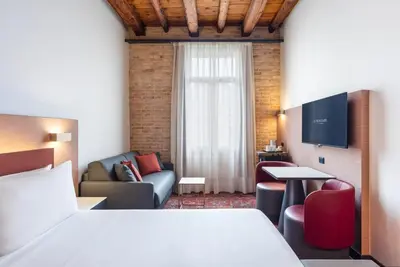 Letto o letti in una camera di Eurostars Residenza Cannaregio