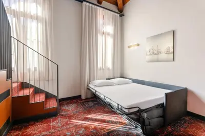 Letto o letti in una camera di Eurostars Residenza Cannaregio