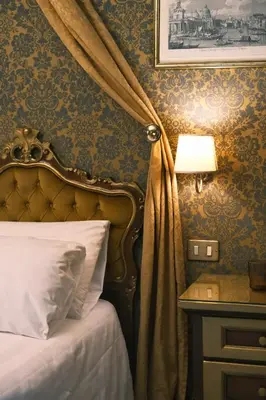 Letto o letti in una camera di ll H O T E L S A N G A L L O ll