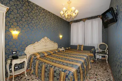Letto o letti in una camera di Hotel Il Mercante di Venezia
