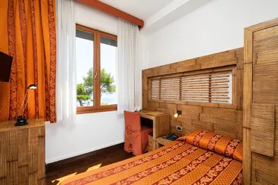 Letto o letti in una camera di Hotel Rivamare