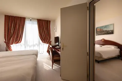 Letto o letti in una camera di Noventa Hotel