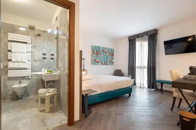Letto o letti in una camera di Ancora Sport Resort Hotel