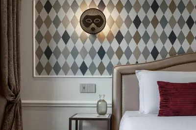 Letto o letti in una camera di Hotel Arlecchino
