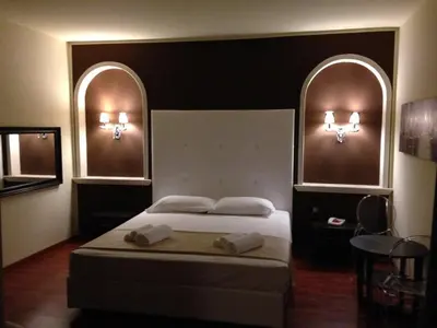 Letto o letti in una camera di Momi's Hotel