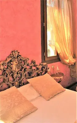 Letto o letti in una camera di Relais Alcova del Doge