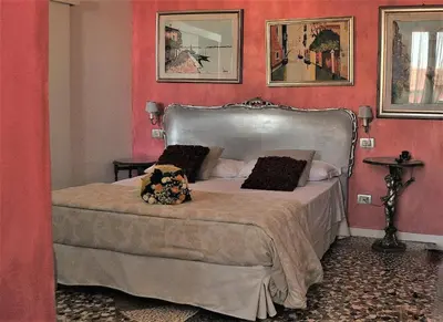 Letto o letti in una camera di Relais Alcova del Doge