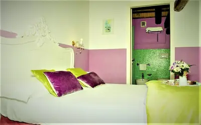 Letto o letti in una camera di Relais Alcova del Doge