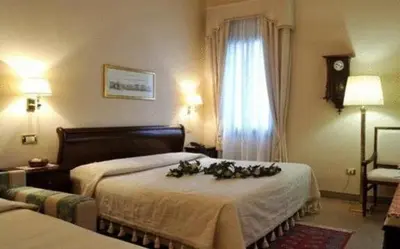 Letto o letti in una camera di Villa Crispi