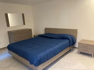 Letto o letti in una camera di Appartamento Tre Archi con corte privata