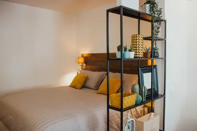 Letto o letti in una camera di BELLINI LIVING APARTMENTS