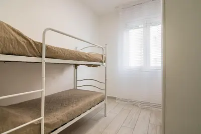 Letto o letti in una camera di [Piazza Mazzini] Appartamento a 2 passi dal mare.