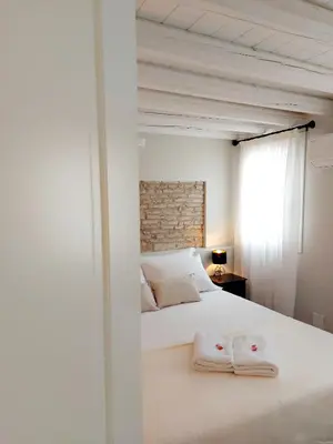 Letto o letti in una camera di Canal Vena ApartSuite House Chioggia
