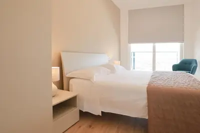 Letto o letti in una camera di Podium - QUI VENDE Immobiliare - per solo Famiglie