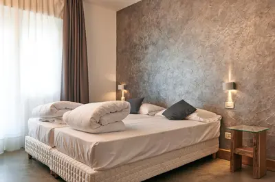 Letto o letti in una camera di HG Hotel Due Ragni