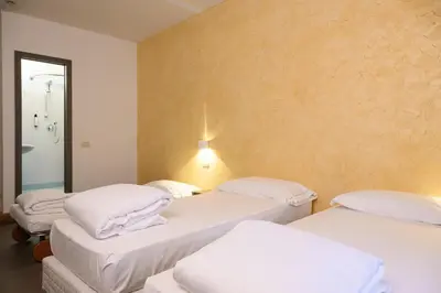 Letto o letti in una camera di HG Hotel Due Ragni