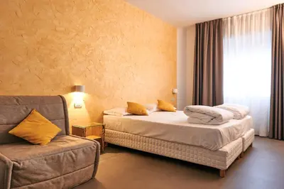 Letto o letti in una camera di HG Hotel Due Ragni