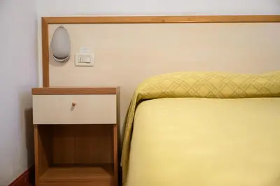 Letto o letti in una camera di HG Hotel Due Ragni