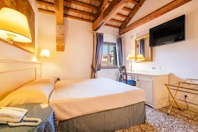 Letto o letti in una camera di Hotel Bella Venezia