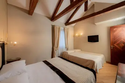 Letto o letti in una camera di Hotel Paganelli