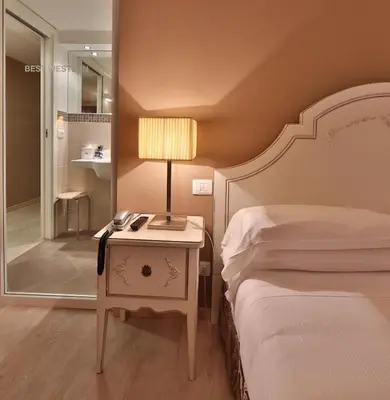 Letto o letti in una camera di Hotel Canon d'Oro