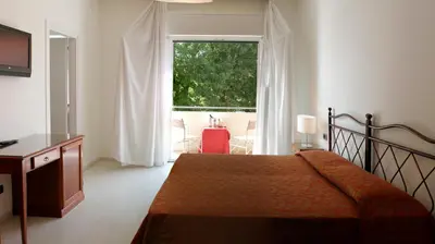Letto o letti in una camera di Hotel Sorriso