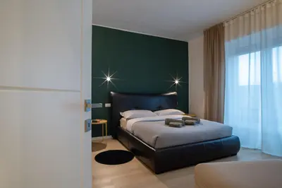 Letto o letti in una camera di BR Treviso Train Station Apartments