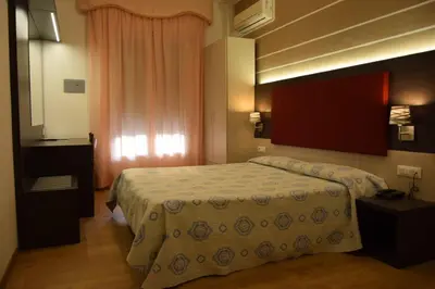 Letto o letti in una camera di Hotel Verdi