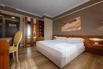 Letto o letti in una camera di iH Hotels Padova Admiral