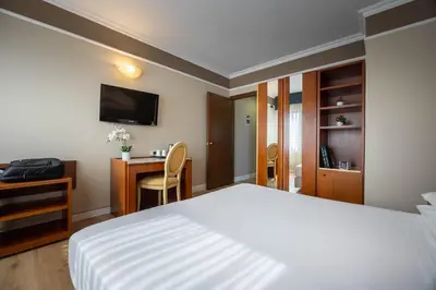 Letto o letti in una camera di iH Hotels Padova Admiral