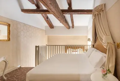 Letto o letti in una camera di Maison Venezia | UNA Esperienze