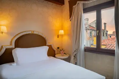 Letto o letti in una camera di Maison Venezia | UNA Esperienze