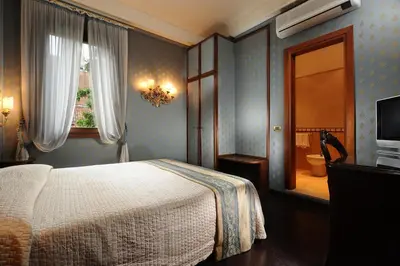 Letto o letti in una camera di Hotel Abbazia