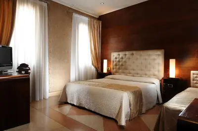 Letto o letti in una camera di Hotel Abbazia
