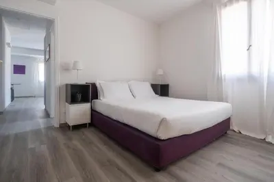 Letto o letti in una camera di Bright Apartment On Venetian Roofs R&R